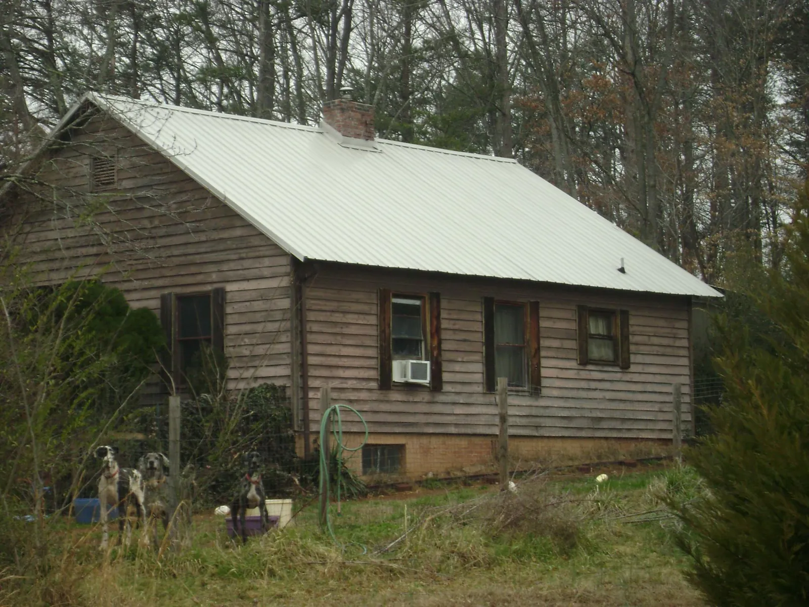 White metal roof on an old wood sided farmhouse, from a Metal Roof Installation job in Linwood
